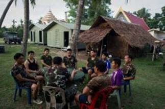 Description: Thai soldiers during an evening briefing at their army base inside Wat Lak Muang, in the southern Thai city of Pattani. Since a deadly insurgency erupted in the Muslim-dominated region seven years ago, the army has become inseparable from religious rituals in the region.