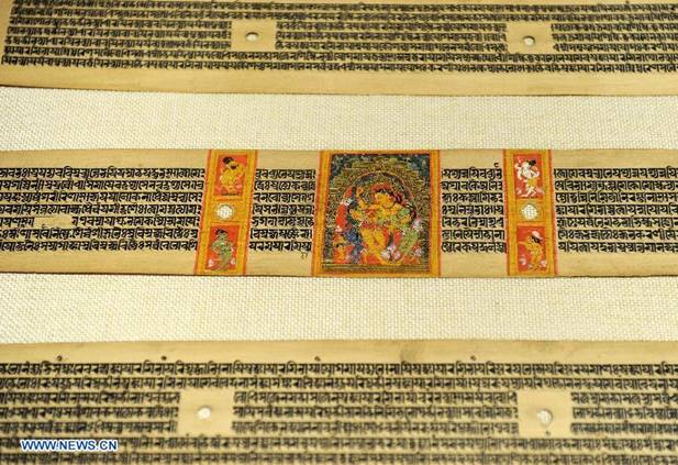 Photo taken on Nov. 21, 2012 shows the photocopy of Palm-Leaf Manuscripts of Buddhist Sutras in Lhasa, capital of southwest China's Tibet Autonomous Region. The palm-leaf manuscripts of Buddhist sutras have been well preserved in China. Palm-Leaf sutras refer to the Buddhist classics inscribed on the leaves of palm trees