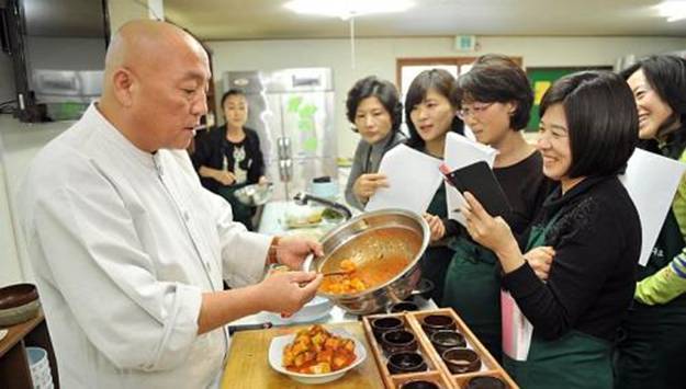 South Korean Buddhist monk Jeokmun (left) teaching his techniques to a dozen students at his Sudoksa temple in Pyeongtaek City, about 60km south of Seoul. A centuries-old tradition of Buddhist cuisine, with strict bars on foods linked to lust or anger, is enjoying a revival in South Korea, one of Asia's most high-stress societies. -- PHOTO: AFP
