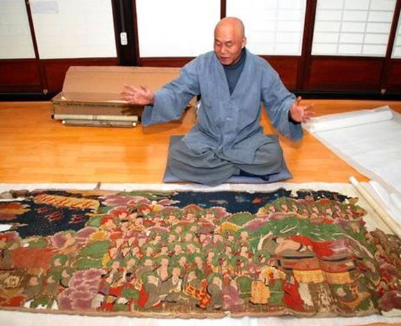 Description: Buddhist monk Jong Geol discusses a Korean Buddhist painting he purchased through a Japanese website at Dongguksa temple in Gunsan, South Korea. An expert's assessment determined it is a valuable "cultural asset-class" Buddhist painting. (Akira Nakano) 