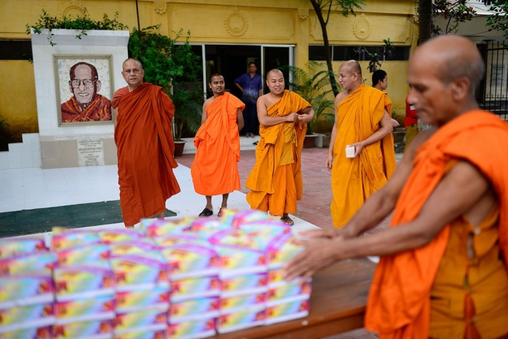 Suddhananda Mahathero, far left, the monasterys head monk, oversees the monks as they ready the food for distribution. Photo by Mahmud Hossain Opu. From aljazeera.com