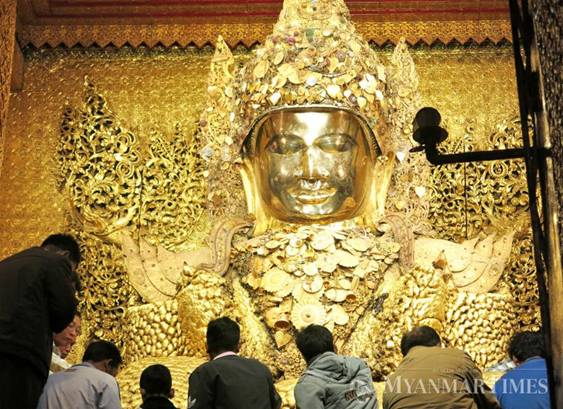 Description: People gather before the Mahamuni Buddha. Phyo Wai Kyaw/The Myanmar Times