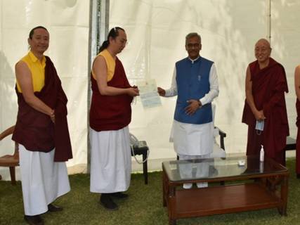 Description: Community leaders presented a cheque to CM Trivendra Singh Rawat. Photo/ANI