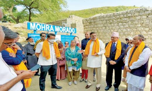 Participants of Vesak Day event receive a briefing at Mohra Maradu Stupa near Taxila on Monday.  Dawn